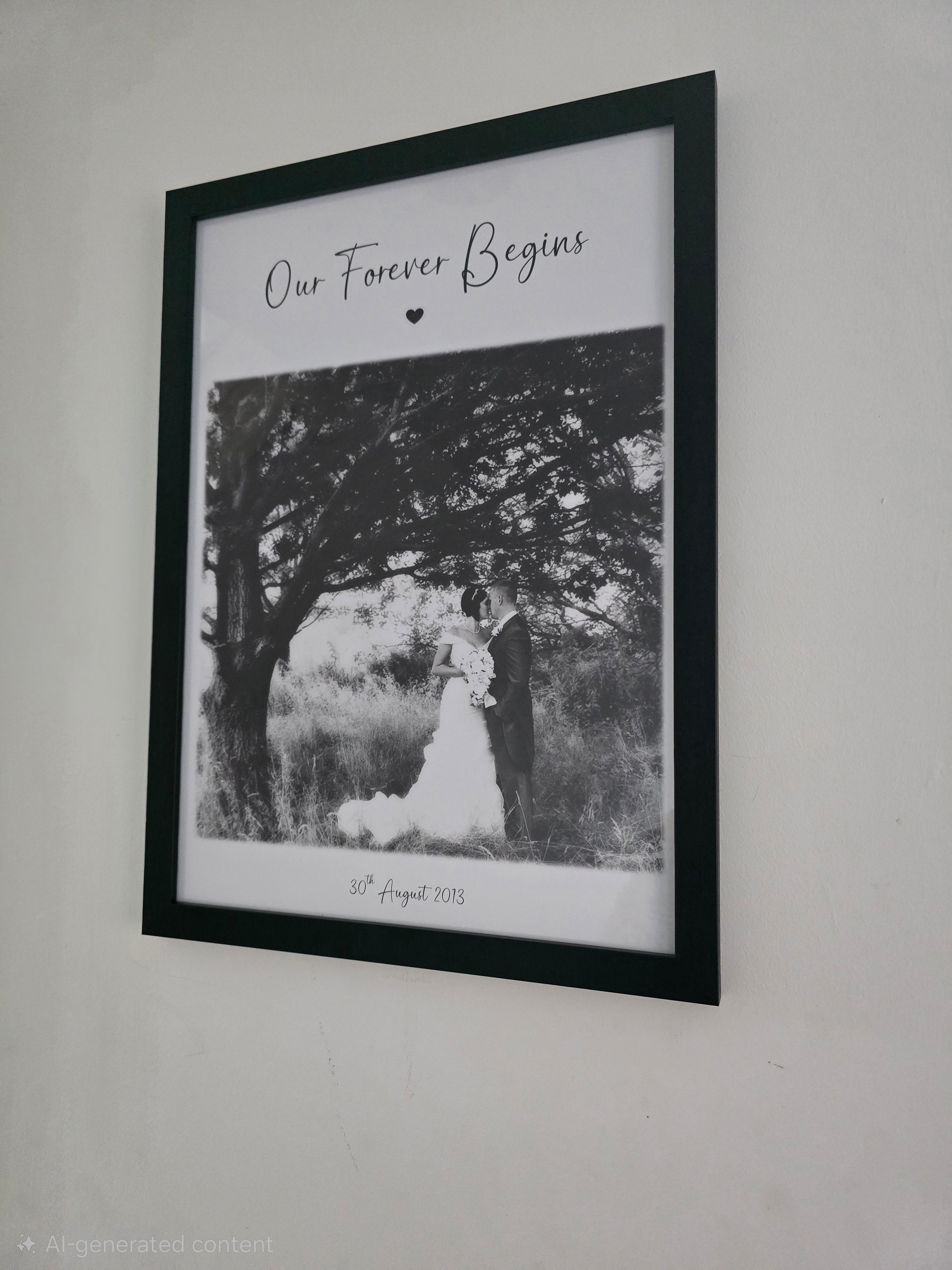 Framed black and white photo of a couple under a tree with 'Our Forever Begins' text.